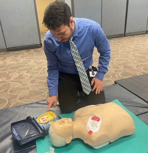 A PAM Health staff member learns how to use an AED to help save lives.