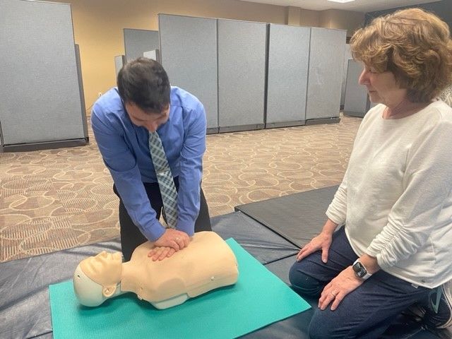 A PAM Health employee practices CPR under the supervision of an instructor.