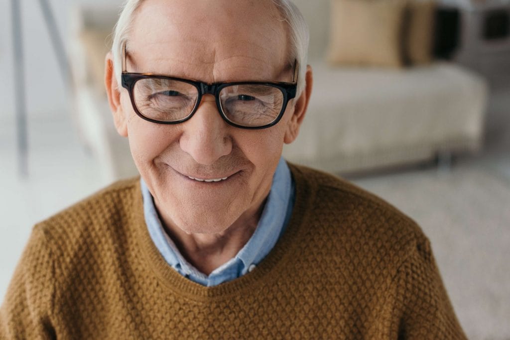 older man in glasses smiling