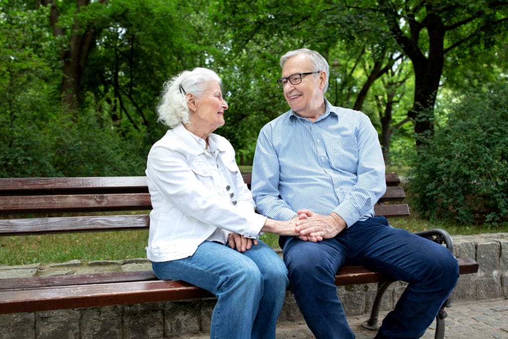 older couple sitting on a bench