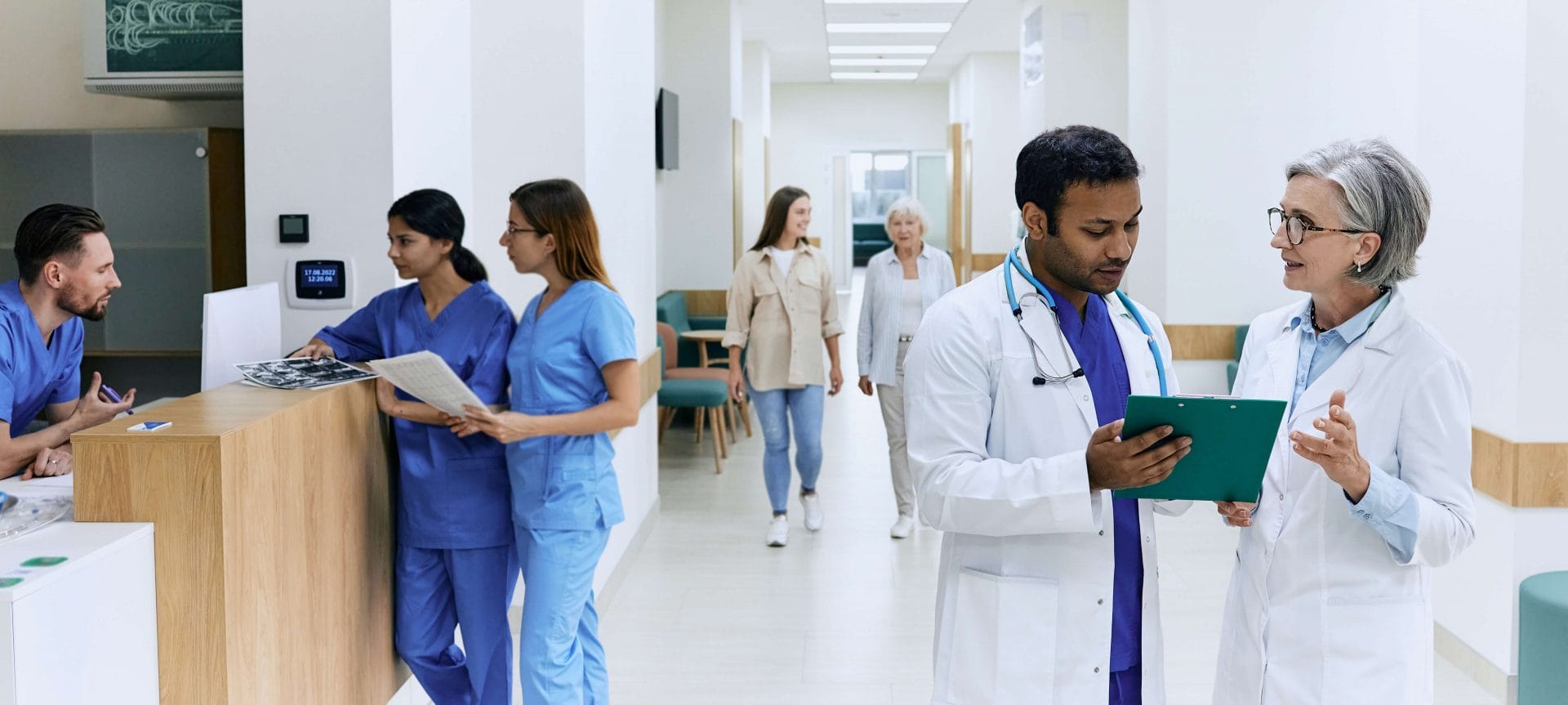 team of healthcare professionals talking near nurses' station