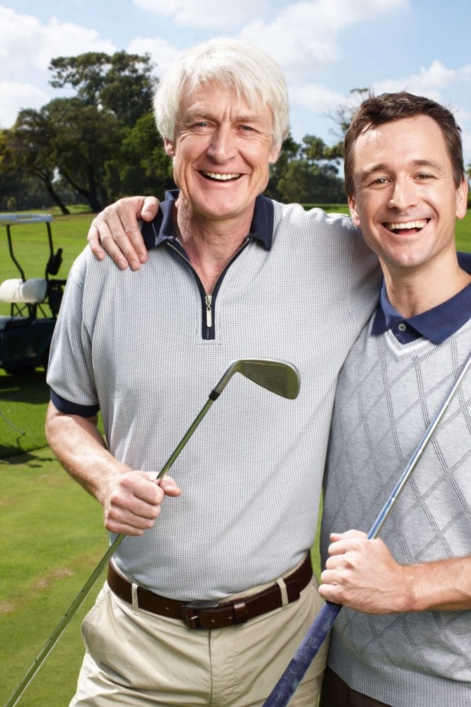 two golfers holding clubs