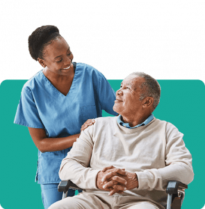 An old gentleman in a chair with a nurse