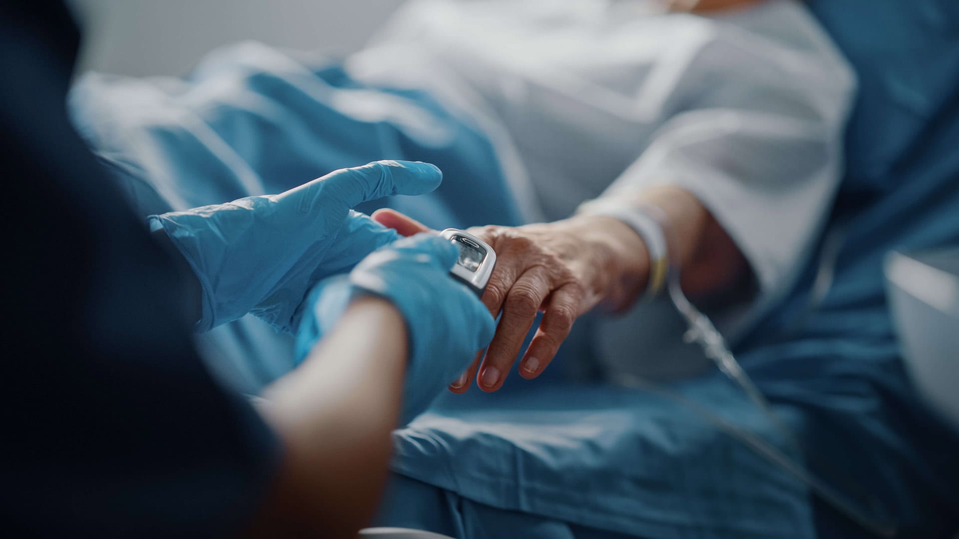 A nurse testing a patient in bed